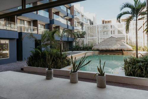 a swimming pool in the middle of a building at Selina Tulum Downtown in Tulum