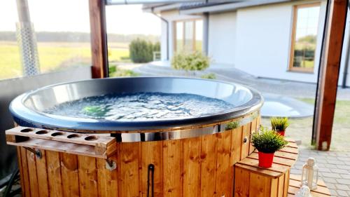 a hot tub sitting on a wooden deck at Agrosielanka in Lipnica