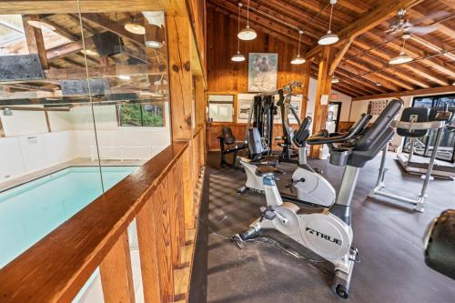 a fitness room with a swimming pool and a gym at Mountainside at Stowe in Stowe