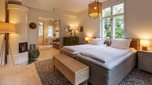 a bedroom with a large bed and a living room at Villa Maija 4 Upperside in Hanko