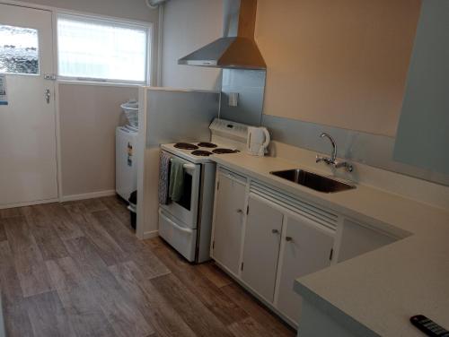 a kitchen with a sink and a stove top oven at City Central in Nelson