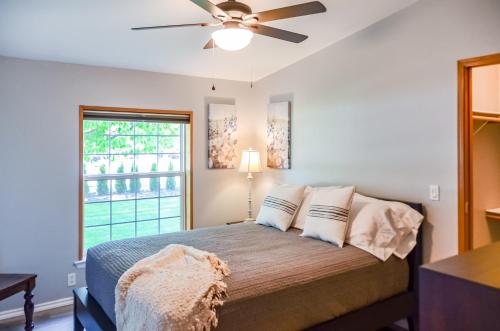 a bedroom with a bed with a ceiling fan at Peak View Corvallis - Spacious Outdoor Dining w/Fire Table - Close to Downtown & OSU in Corvallis
