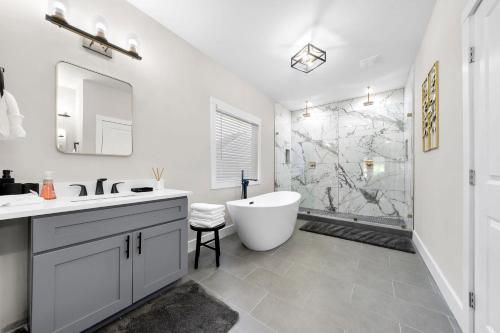 a bathroom with a tub and a sink and a shower at Family Friendly New Luxury Home Centrally located in Atlanta