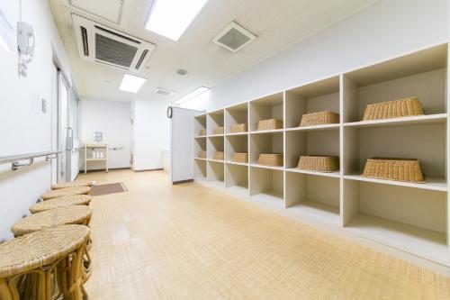 a room with shelves and a table and chairs at Hotel Crystal Palace in Hitachinaka