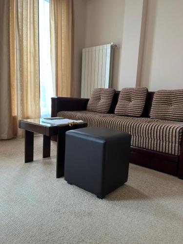 a living room with a couch and a coffee table at B&B Vila Vidikovac in Arandjelovac