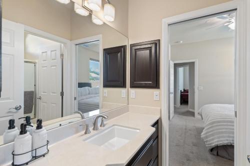a bathroom with a sink and a large mirror at Palms Place in Indio in Indio