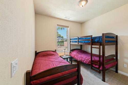 a bedroom with two bunk beds and a window at Palms Place in Indio in Indio