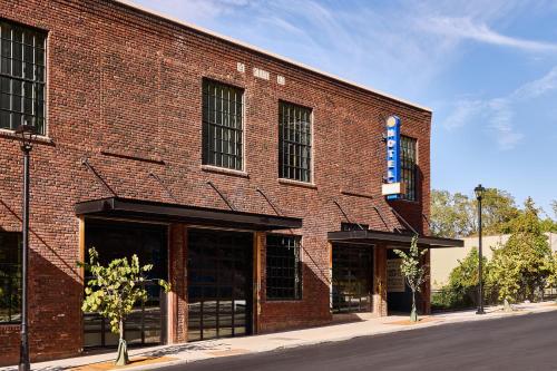 a red brick building with a sign on it at The Radical Asheville, Tapestry Collection by Hilton in Asheville