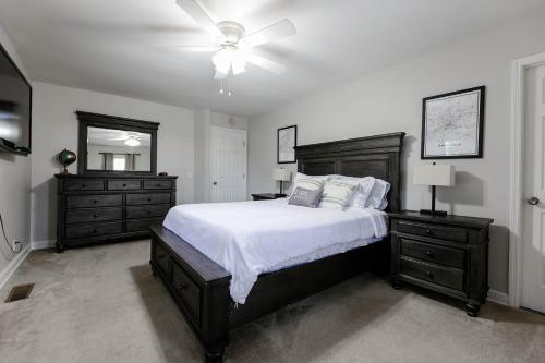 a bedroom with a large bed and a ceiling fan at Rockin' West Nashville Retreat - 5 miles from downtown in Nashville