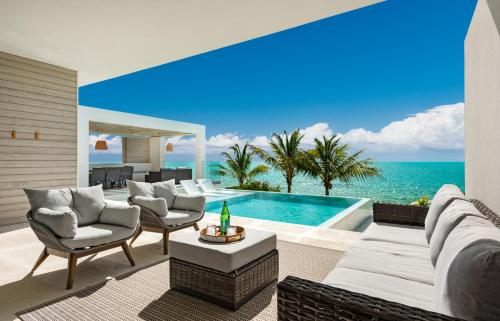 a living room with a view of the ocean at Ocean Dream 5 BR Villa Aqua in Long Bay Hills