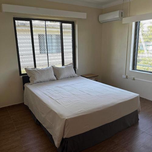 a large bed in a room with a large window at KumarVacation Home 38 Kennedy Road Unit 2 in Nadi