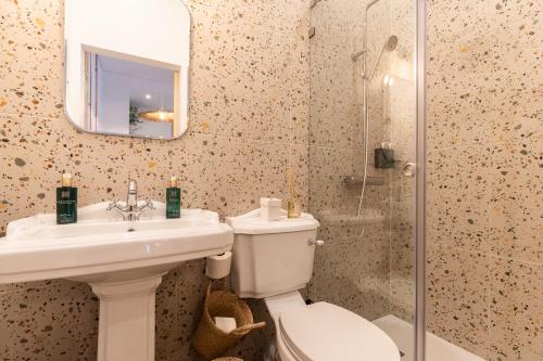 a bathroom with a toilet and a sink and a shower at Amália Boutique Suites & Studios - by @ rita´s place in Faro