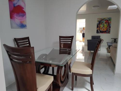 a dining room with a glass table and chairs at Apartamento1 bien ubicado en Tuluá in Tuluá