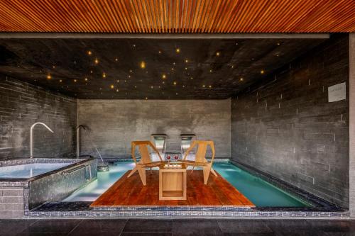 a swimming pool with a table and chairs in a house at Grand Fiesta Americana Monterrey Valle in Monterrey