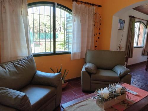a living room with two couches and a window at La Ilusión in Campos Salles