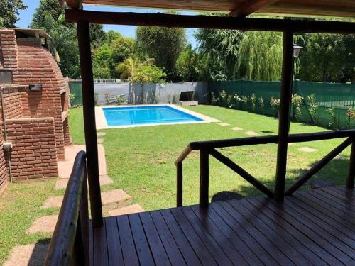 a deck with a view of a swimming pool at El Descanso in Roldán