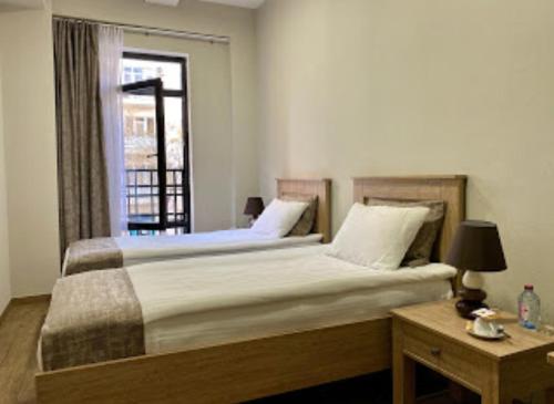 a bedroom with a large bed and a window at Nizami Street Hotel in Baku