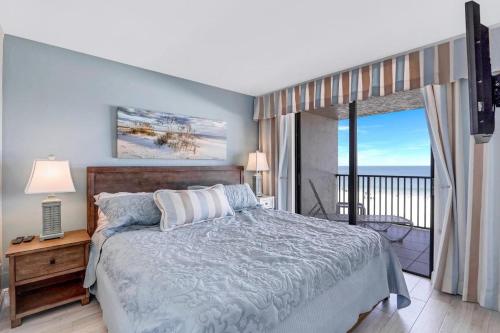 a bedroom with a bed with a view of the ocean at Ideally situated beachfront condo with pool and views in Marco Island