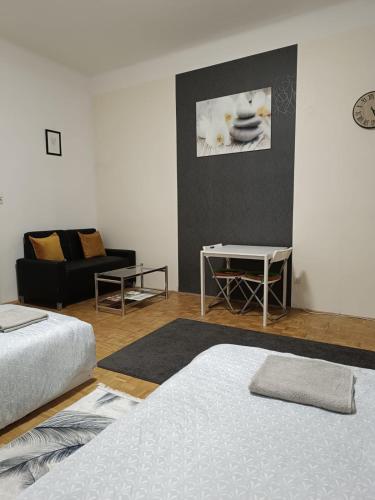 a living room with two beds and a couch at Wohnung in der nähe Wiener Stadthalle und Zentrum in Vienna
