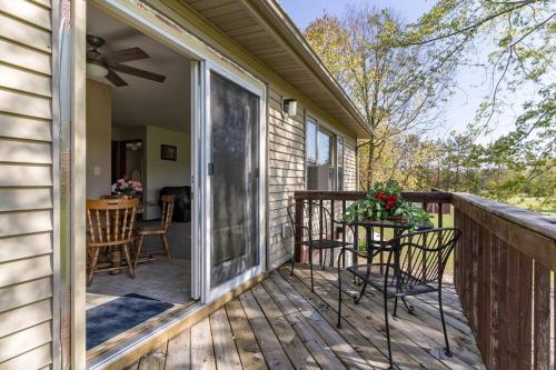 a porch with a table and chairs on a deck at Bass Creek's Apt A in Janesville