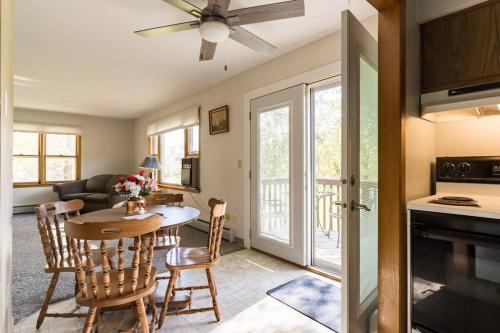 a kitchen and living room with a table and chairs at Bass Creek's Apt A in Janesville
