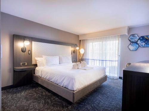 a hotel room with a large bed and a window at DoubleTree by Hilton Livermore, CA in Livermore