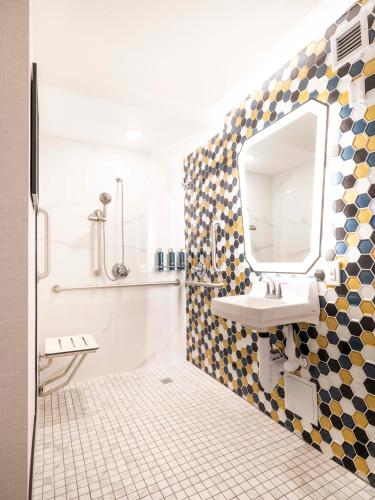 a bathroom with a sink and a mirror on the wall at DoubleTree by Hilton Livermore, CA in Livermore