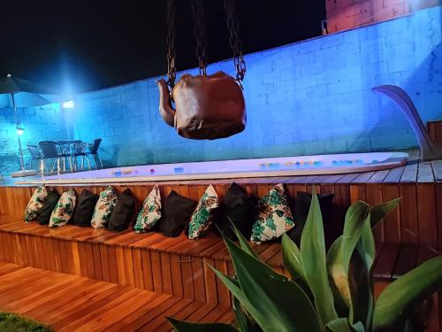 a bench with pillows and a purse on it at Hostel Trem Di Durmi in Belo Horizonte