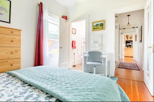 a bedroom with a bed and a desk and a chair at Private room in the heart of Elmwood Berkeley! in Berkeley