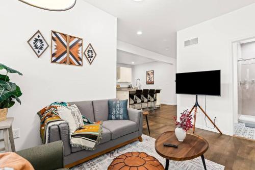 a living room with a couch and a tv at Tranquil Haven Retreat in Detroit