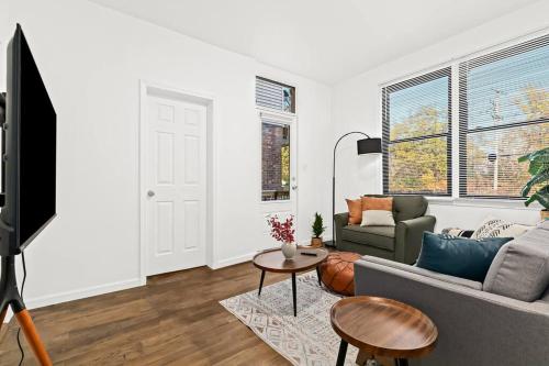 a living room with a couch and a table at Tranquil Haven Retreat in Detroit