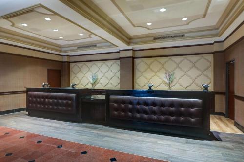 a waiting room with leather seats in a building at Drury Plaza Hotel New Orleans in New Orleans
