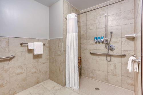 a bathroom with a shower with a shower curtain at Drury Inn & Suites Cincinnati Northeast Mason in Mason