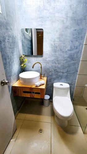 a bathroom with a sink and a toilet at Luxury Home In Aguacatala in Medellín