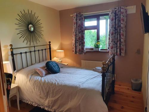 a bedroom with a bed with a pillow on it at Hillcrest House in Carrick on Shannon