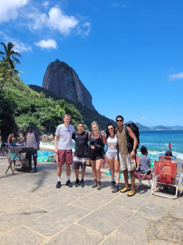 a group of people standing in front of the beach at Hostel Sunrise in Rio de Janeiro