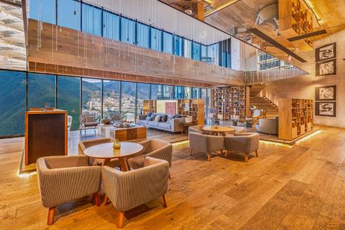 a large room with tables and chairs and large windows at Live Aqua Monterrey in Monterrey