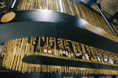 a bunch of champagne bottles hanging from a ceiling at The Radical Asheville, Tapestry Collection by Hilton in Asheville