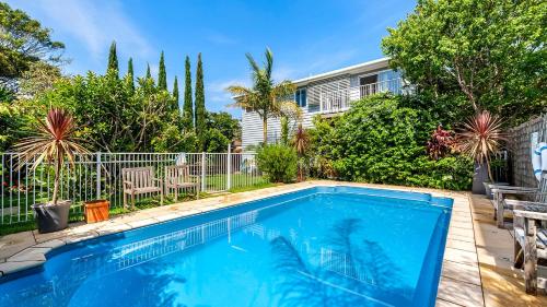 a swimming pool in front of a house at Shoal Bay Riggers - 7 Rigney St, Shoal Bay in Shoal Bay