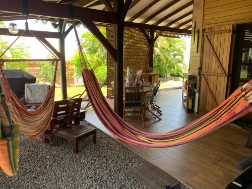 a room with two hammocks in a house at Les Frangipaniers de la Pelée in Saint-Pierre