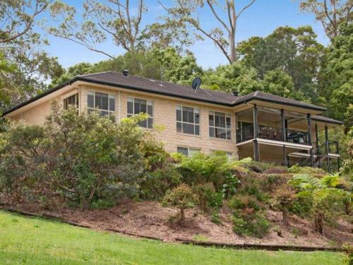 a house on a hill with a yard at *Casa Al Lago* in Montville