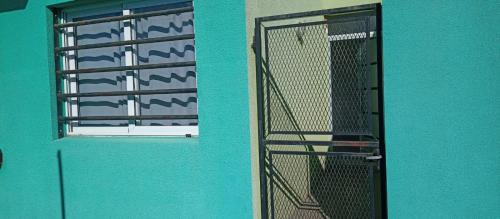 a green building with a door and a window at DEPARTAMENTO BOLIVAR PLANTA BAJA in San Carlos de Bolívar