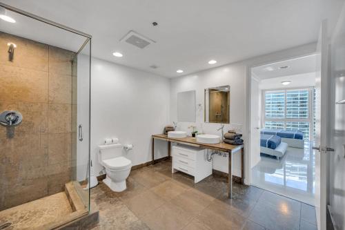 a bathroom with a toilet and a sink and a shower at *W ICON BRICKELL- LUXURY 2BR HIGHRISE CORNER CONDO** in Miami