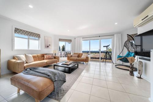 a living room with a couch and a table at Soul Beach House - Beach Family WiFi in Christies Beach