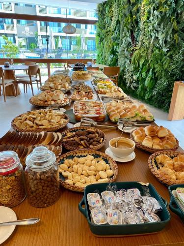 a table with many different types of food on it at Mana Beach Experience Muro Alto C219 in Porto De Galinhas