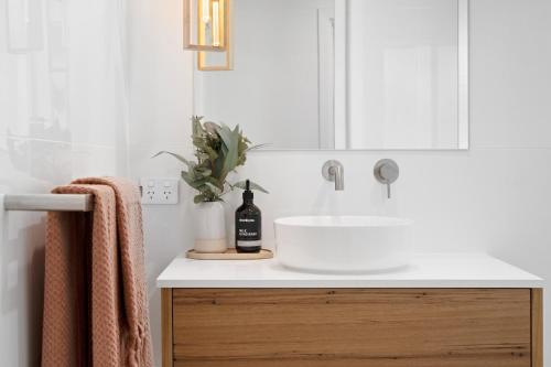 a bathroom with a white sink and a mirror at The Arches ~ Style, location and spacious living! in McLaren Vale