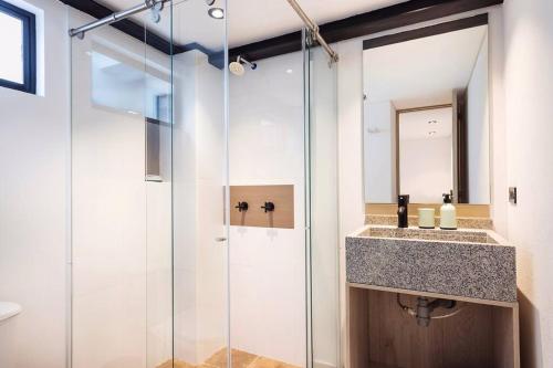 W łazience znajduje się szklana kabina prysznicowa i umywalka. w obiekcie Gorgeous 2/2 in PRIME Location! Brand NEW w mieście Bogota
