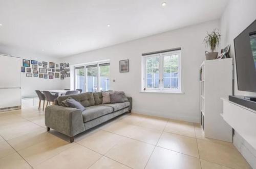 a living room with a couch and a table at Elegant 4-Bed Townhouse in Northampton - Free Parking in Northampton