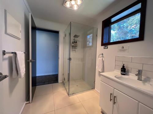 a bathroom with a shower and a sink at Boomers Retreat, Alonnah, Bruny Island in Alonnah