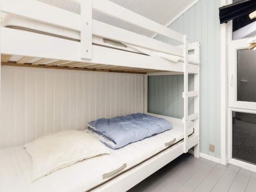 JerupにあるHoliday Home Brattenvejの白い二段ベッドが備わるドミトリールームの二段ベッド1台分です。